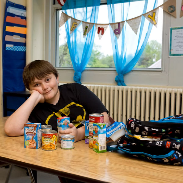 child receiving food in a his backpack